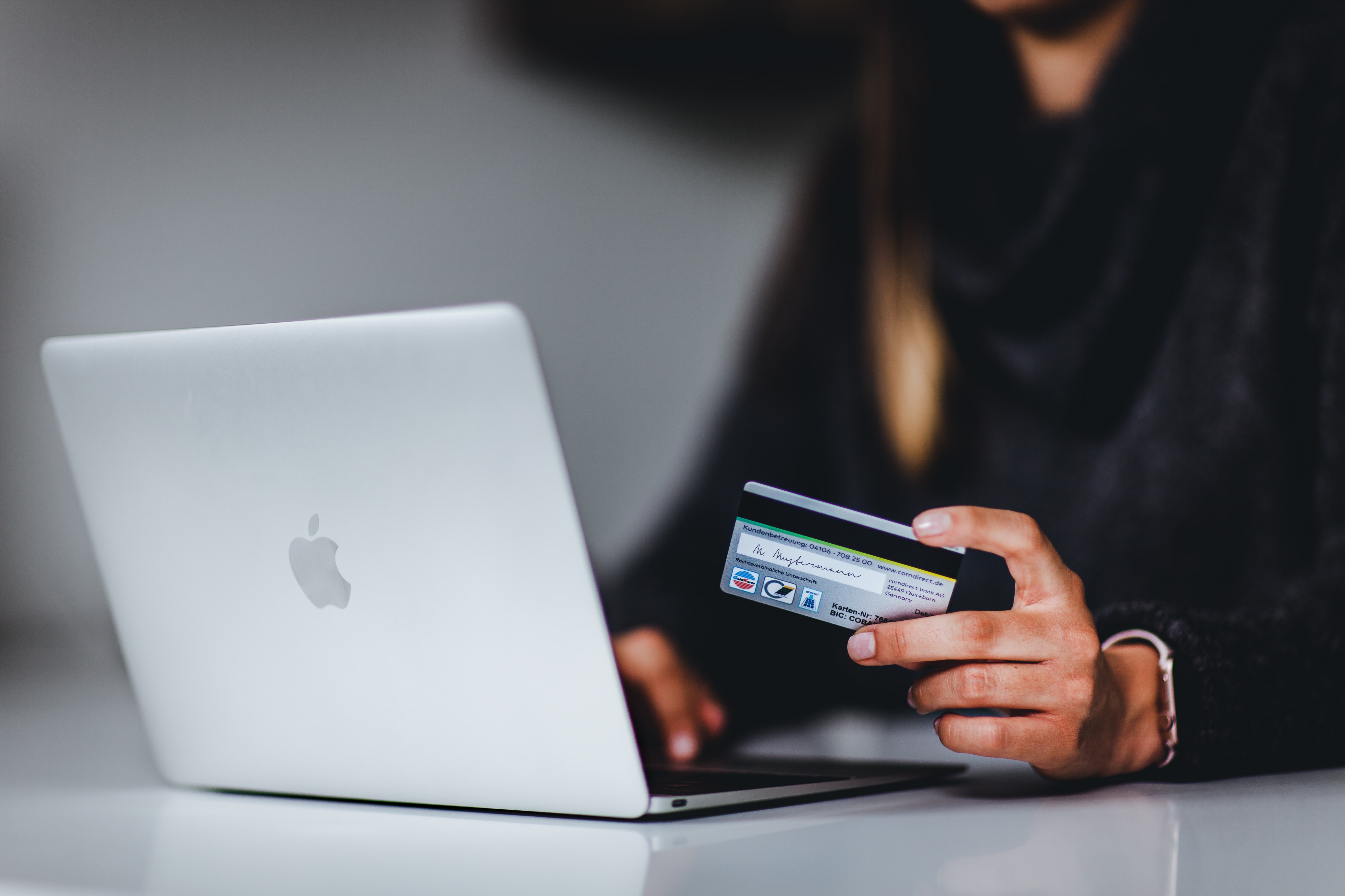 Mac book and credit card; Credit: @pickawood on Unsplash